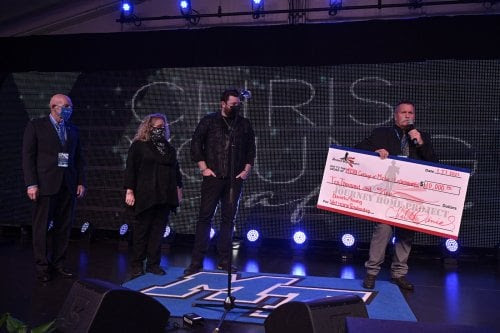 Chris Young with David Corlew and and others on stage for with a check on stage for 10,000 dollars for Daniels/Young Veterans Scholarship at Middle Tennessee State University